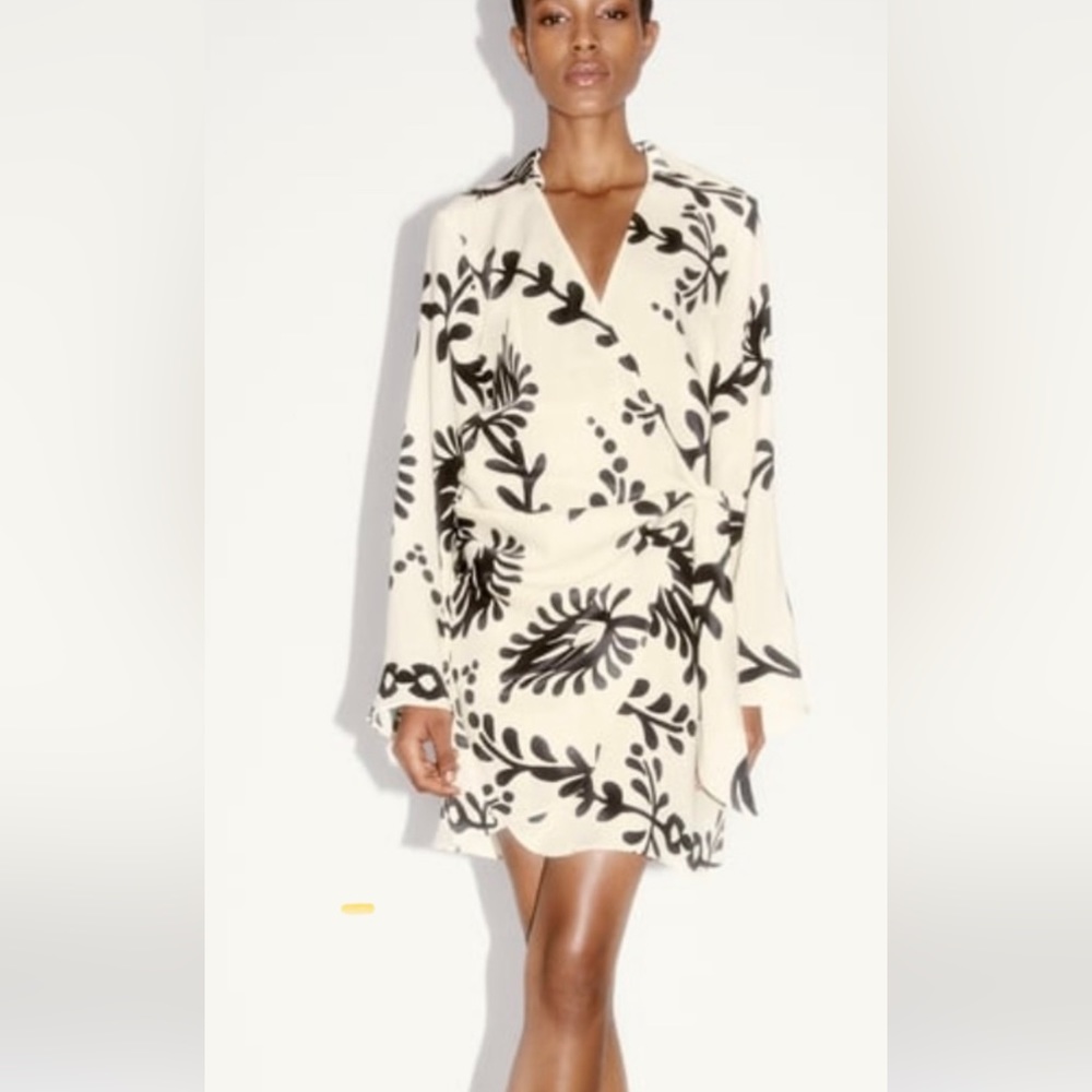 Extremely fun and sophisticated scroll wrap dress with tie at front.
